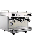 Crem EX2 espresso machine on a wooden surface with a blurred indoor background
