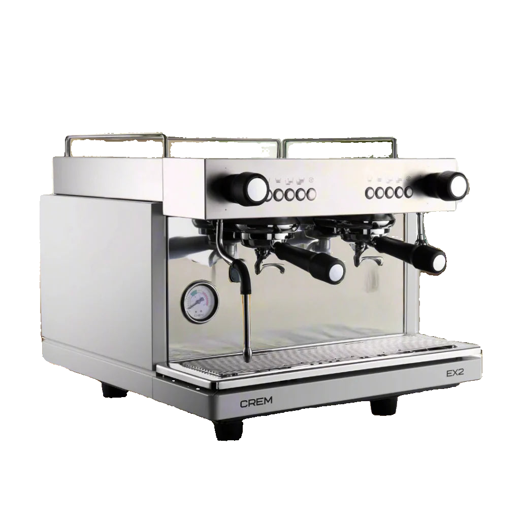 Crem EX2 espresso machine on a wooden surface with a blurred indoor background