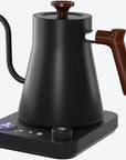 Black electric kettle with wooden handle on a white background